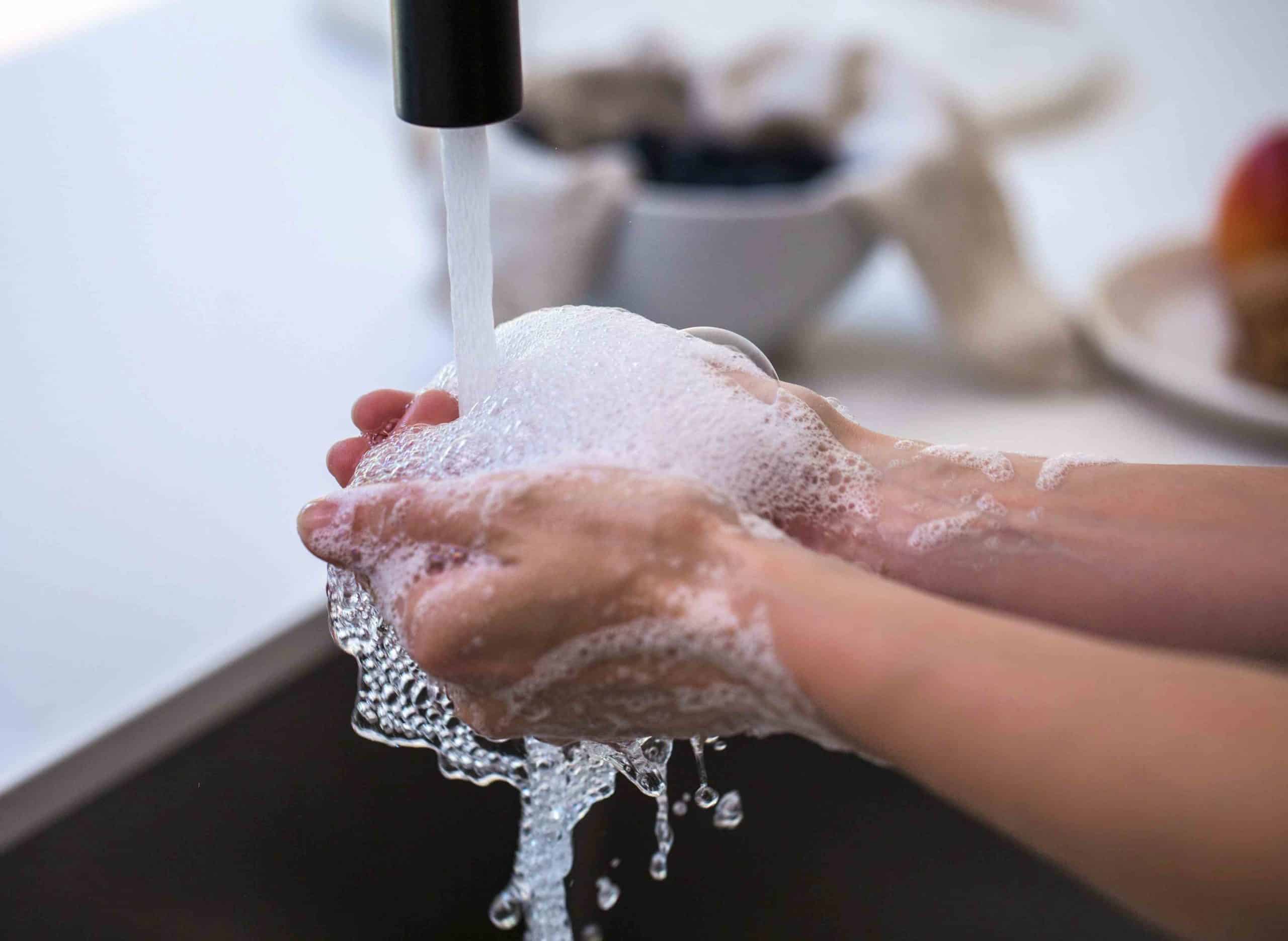 rinsing-soapy-hands-in-water