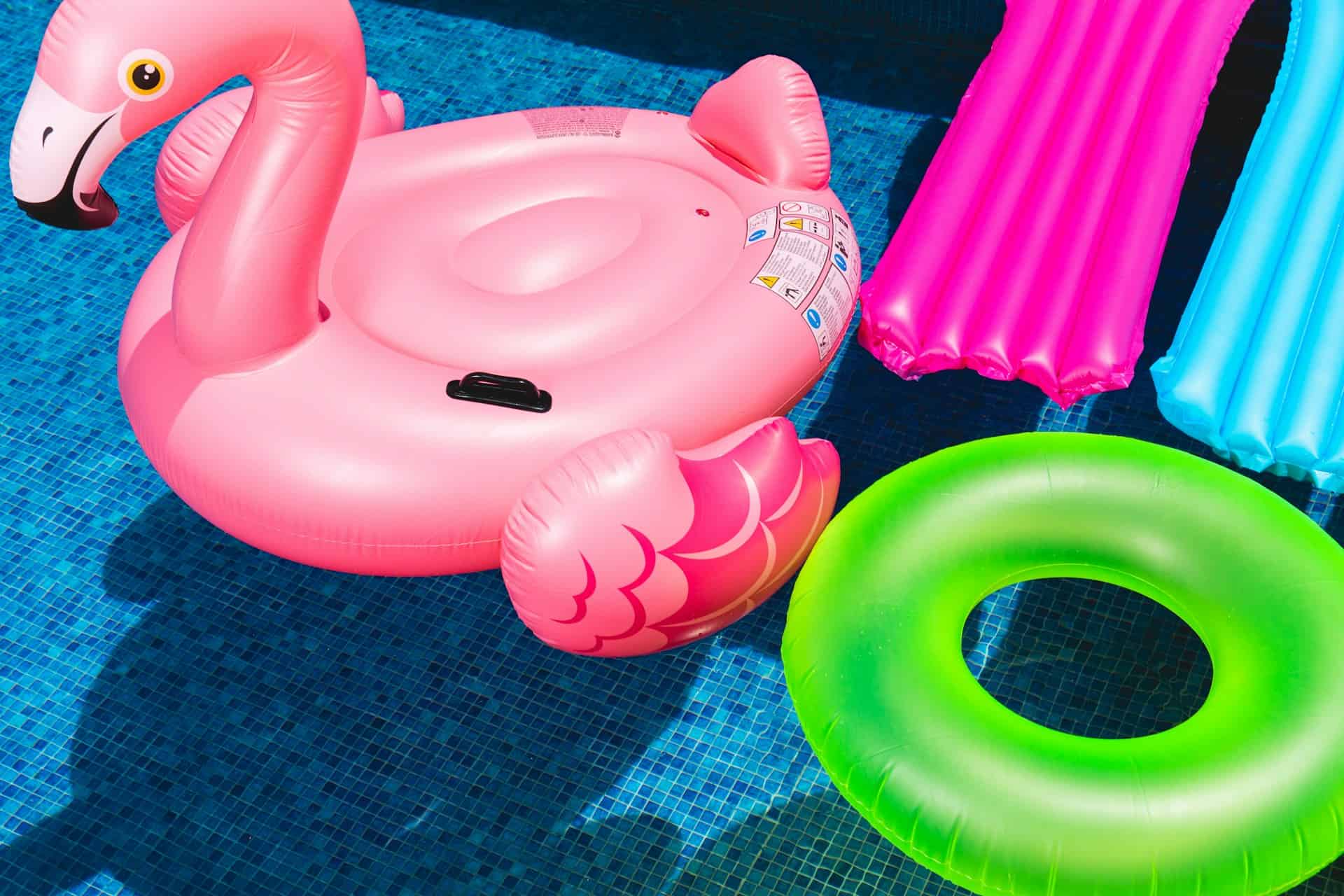 Bright pink flamingo pool float with a built-in cup holder and adorable design.